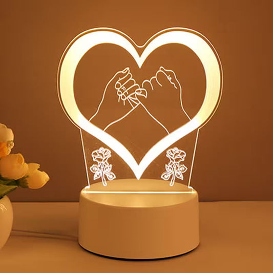 Heart-shaped night light with hands holding flowers and roses on a brown background