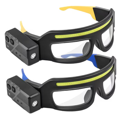 Black safety goggles with yellow accents and a camera module on a white background