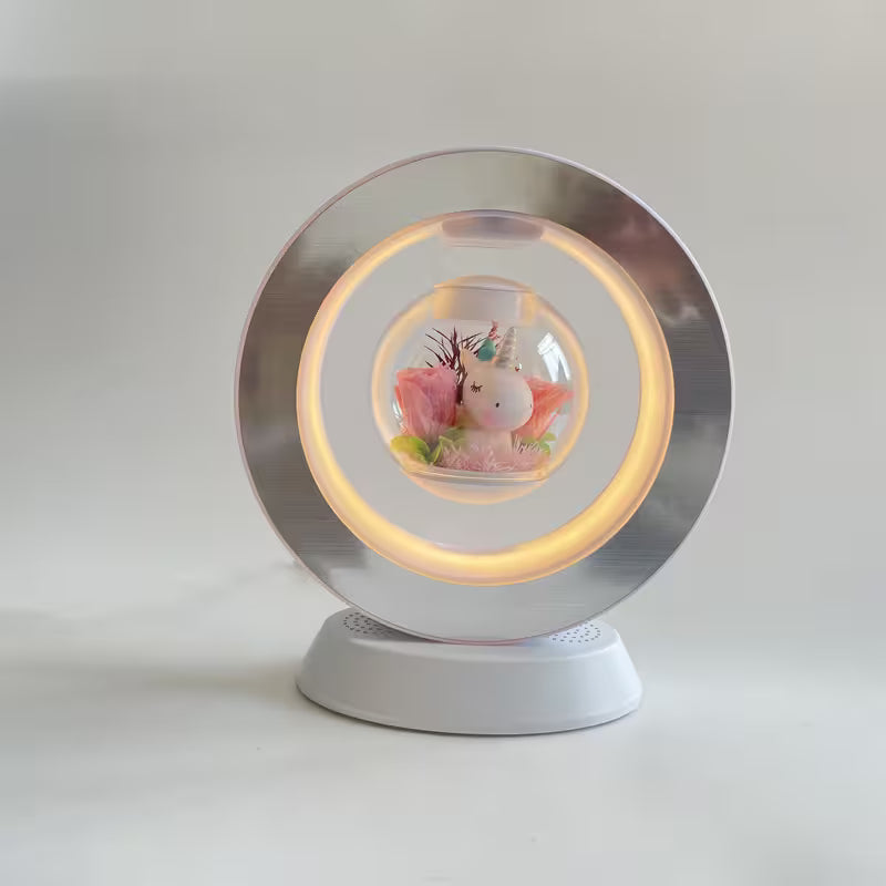 Decorative snow globe with a unicorn figure inside on a white background