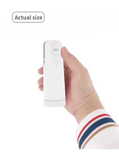 Hand holding a white electronic device against a white background