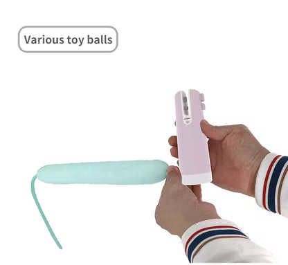 Hand holding a pink and green toy with text 'Various toy balls' on a white background