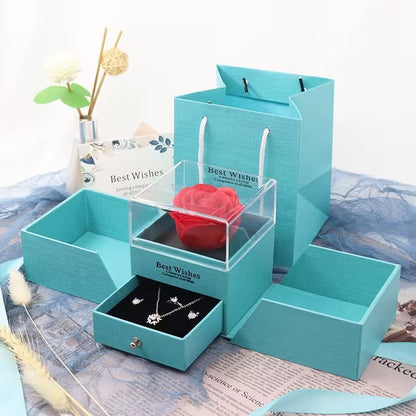 Turquoise jewelry box with a red rose and silver necklace on a white background