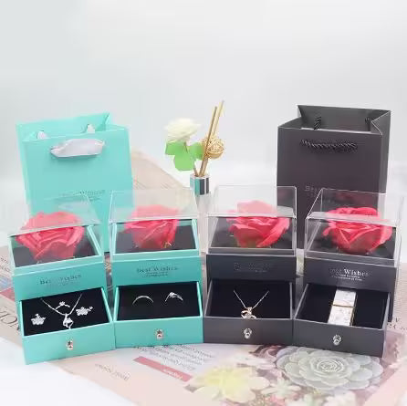 Set of jewelry boxes with red roses and necklaces on a light background