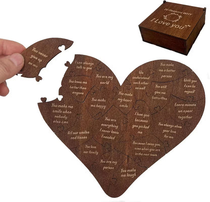 Heart-shaped wooden puzzle with engraved messages and a matching wooden box on a white background