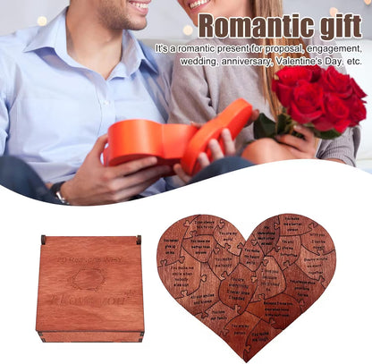 Heart-shaped wooden puzzle with engraved text and a red gift box, surrounded by romantic elements.