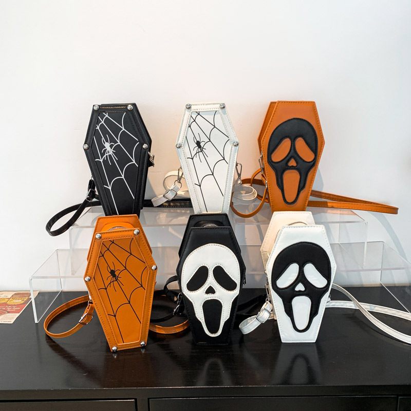 Halloween-themed pouches with coffin design on a clear stand.