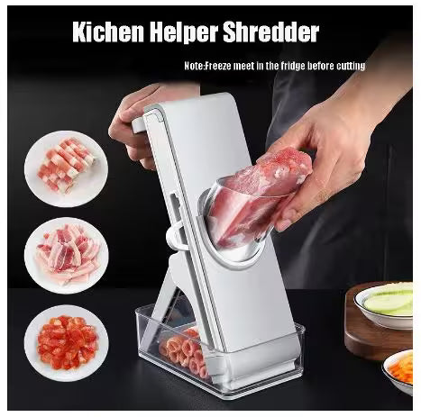 Kitchen Helper Shredder being used to shred meat with a black background