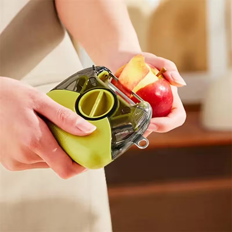 Person using a green apple peeler on an apple with a blurred background