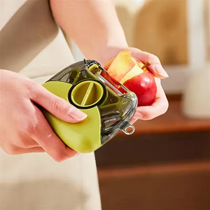 Person using a green apple peeler on an apple with a blurred background