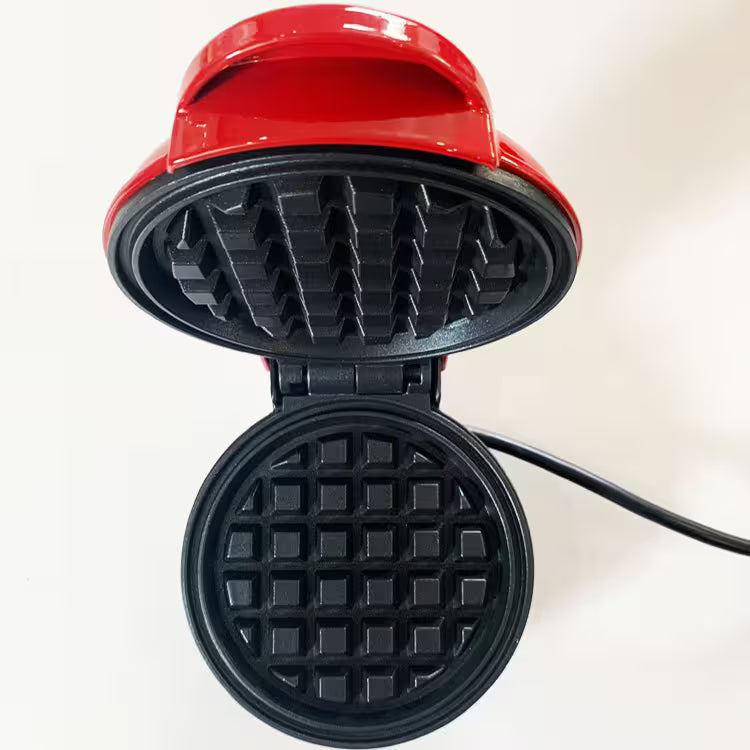 Red waffle maker with open lid on a white background