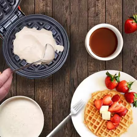 Making a waffle with ingredients on a wooden table