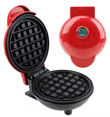 Mini waffle maker with open lid showing waffle pattern, red handle, and green button on a white background.