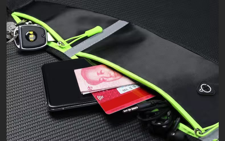 Black pouch with green zipper containing a phone, cards, and keys on a textured black surface.