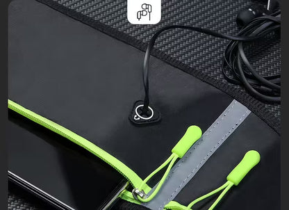 Black pouch with green zipper and earphones on a textured surface