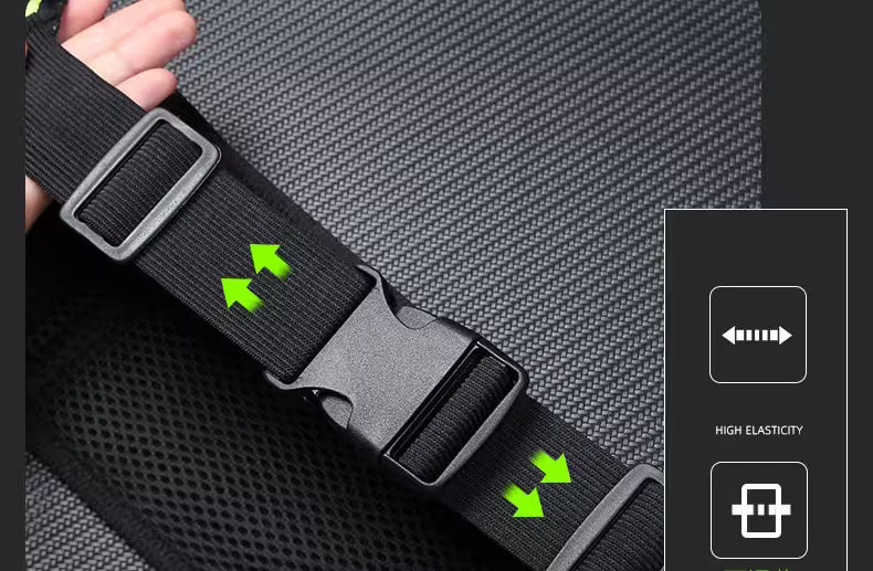 Black belt with adjustable buckle held by a hand on a gray textured background.