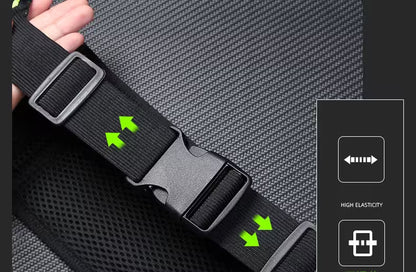 Black belt with adjustable buckle held by a hand on a gray textured background.