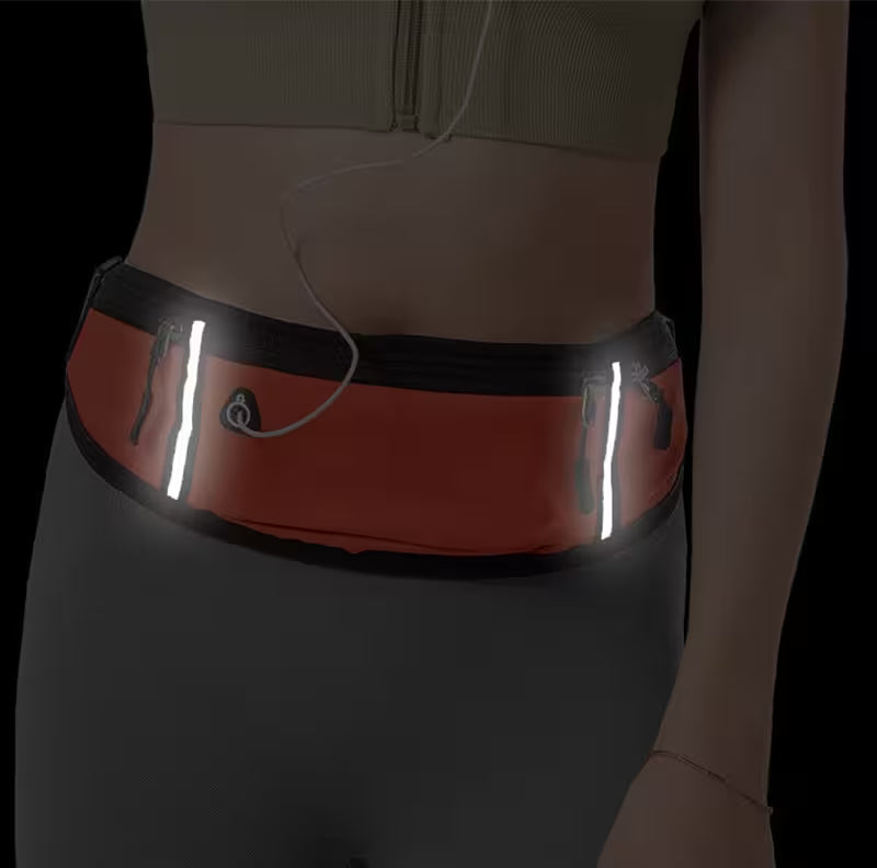 Person wearing a reflective waist bag on a dark background