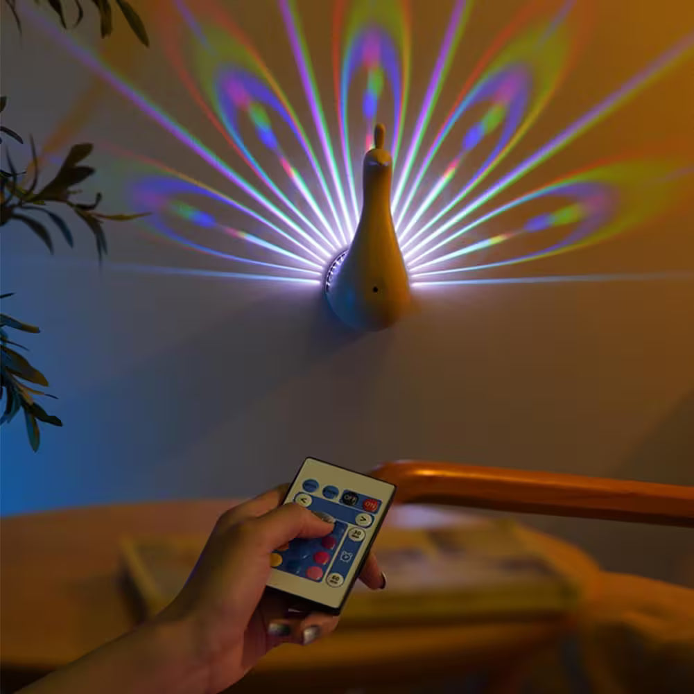 Colorful light show projected by a duck-shaped device with a hand holding a remote control.