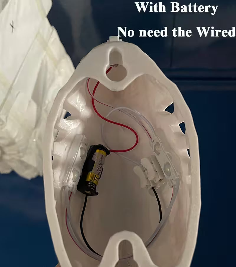 White electronic device with battery and wiring on a dark background