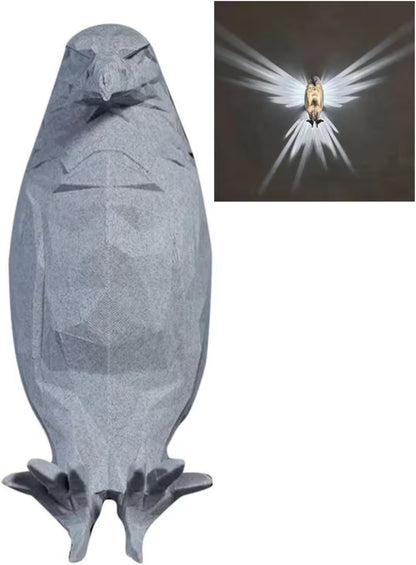 Gray stone sculpture of a bird with inset showing light effect