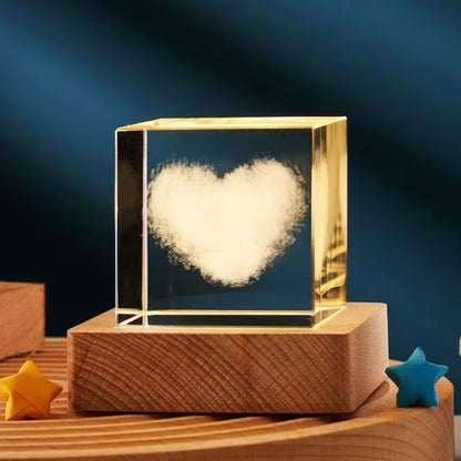 Heart-shaped object inside a transparent cube on a wooden base with a dark blue background