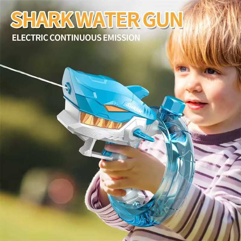 Child holding a shark-shaped water gun with text indicating electric continuous emission.