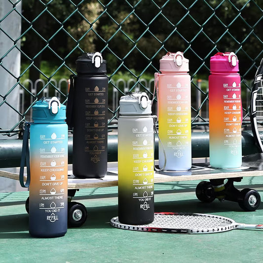 Set of colorful water bottles with motivational text on a sports court background