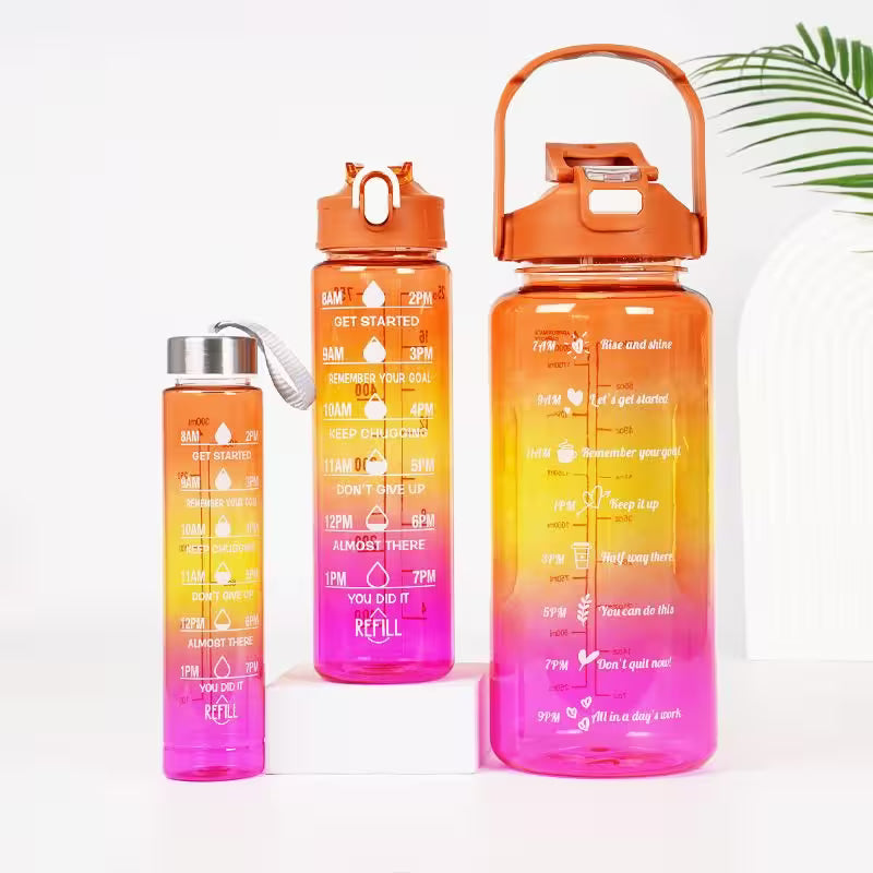 Set of three gradient water bottles with motivational text on a white background