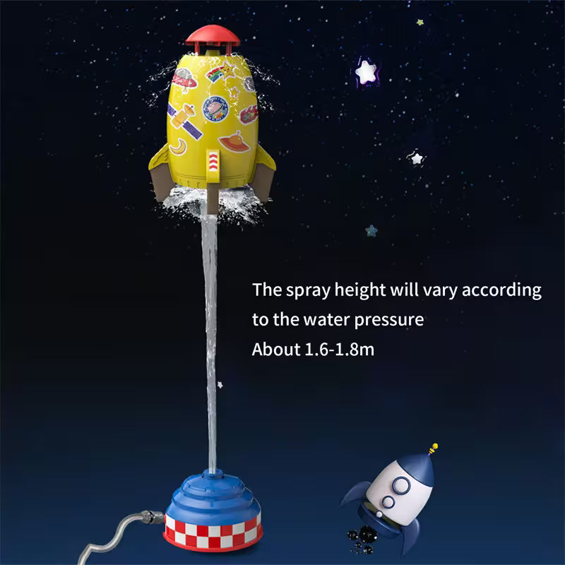 Toy rocket with water spray feature against a starry night sky background