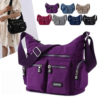 Purple shoulder bag with multiple colors of bags displayed in the background