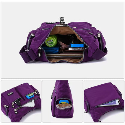 Purple bag with various compartments and items on a white background