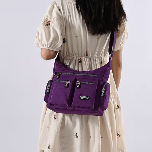 Person wearing a purple backpack with a white background