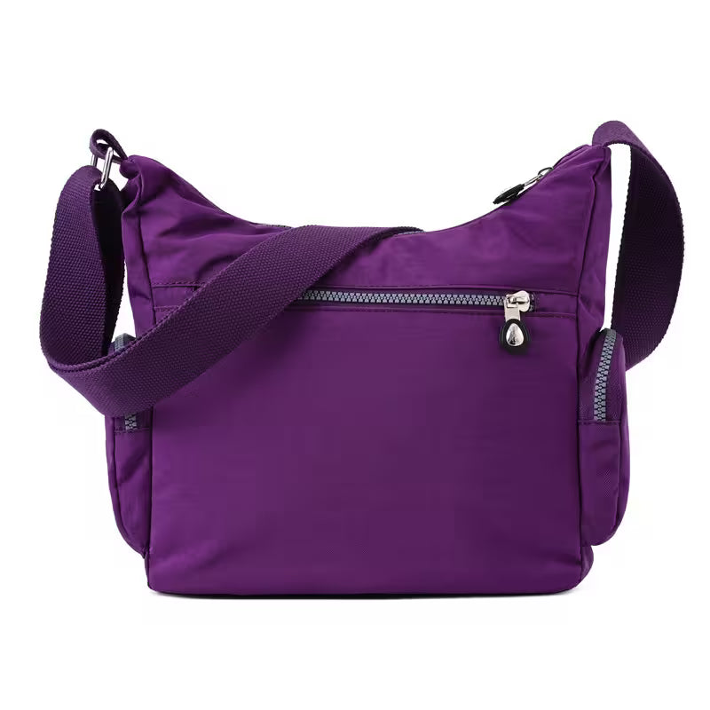 Purple shoulder bag with a strap on a white background
