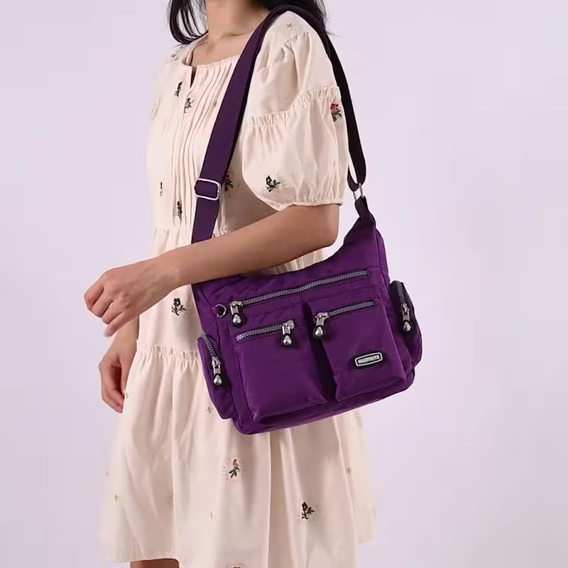 Person wearing a purple shoulder bag on a white background