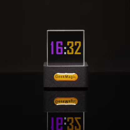 Digital clock with 'GeekMagic' branding on a black background