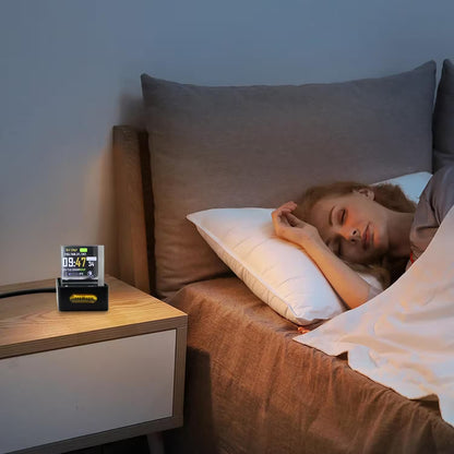 Person sleeping in bed with a digital clock on the nightstand.