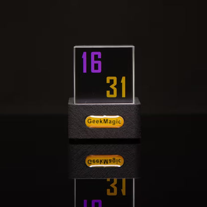 Digital clock with 'GeekMagic' branding on a black background