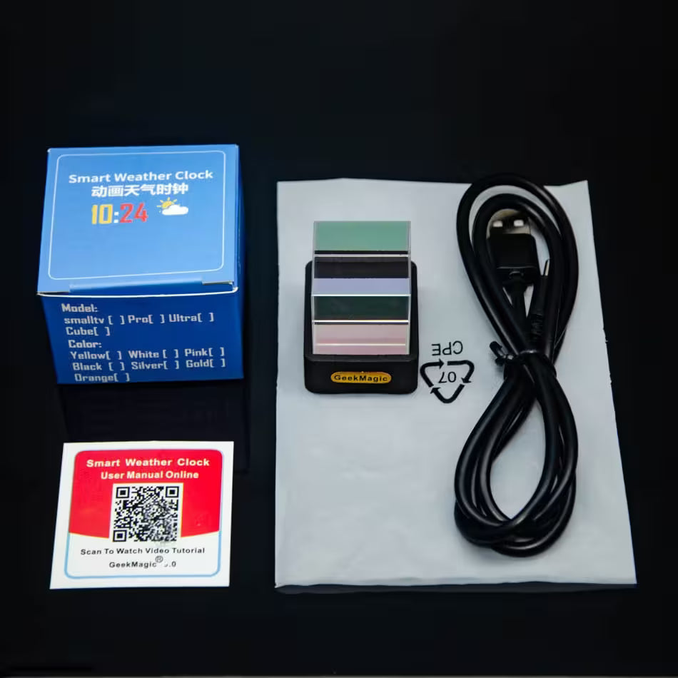 Smart weather clock with packaging, USB cable, and QR code label on a black background
