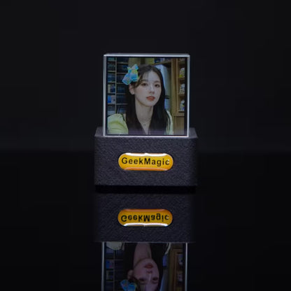 GeekMagic photo frame displaying a person with a flower in their hair on a dark background