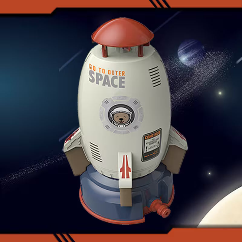 Toy rocket ship with 'Go to Outer Space' text against a space-themed background