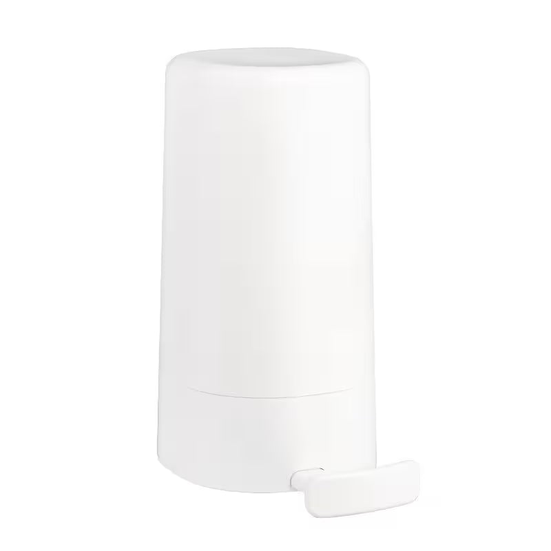 White cylindrical container with a smaller white object on a white background