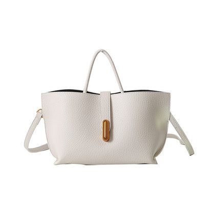 White handbag with a brown buckle on a white background