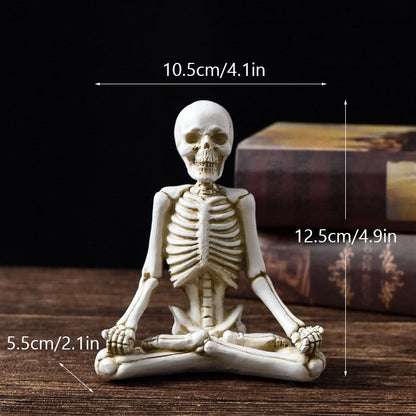 Miniature skeleton figurine in a meditative pose with measurements on a dark background