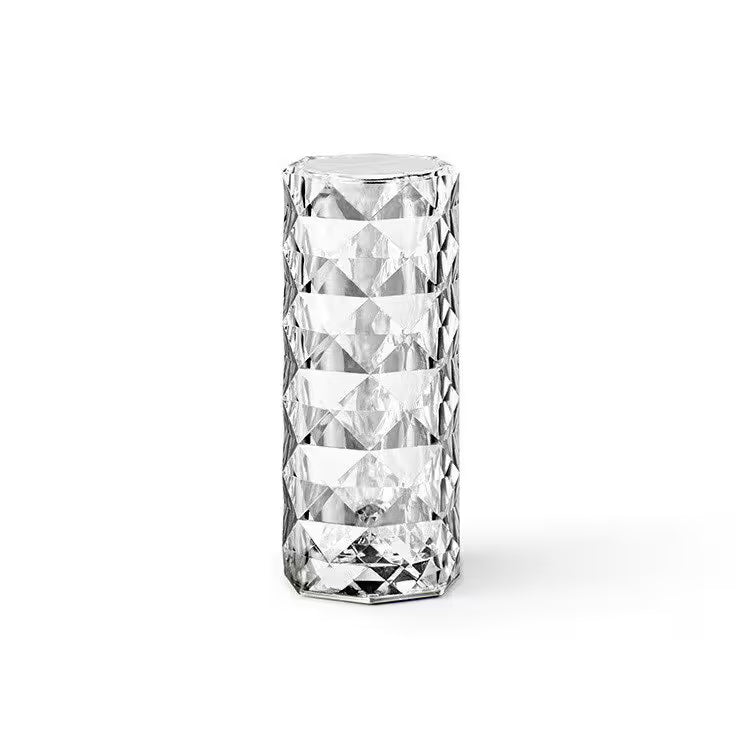 Clear glass vase with diamond-cut pattern on a white background