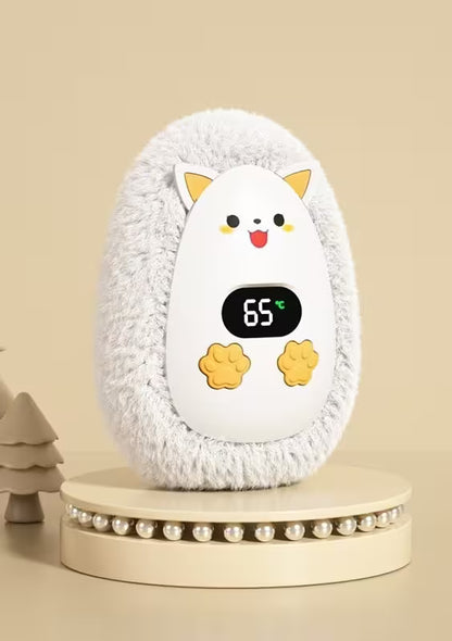 Fluffy white pet heater with cartoon face and digital display on a beige background