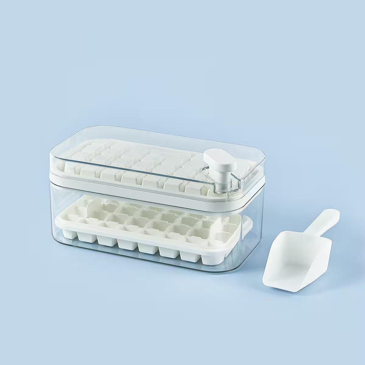Ice cube tray with clear lid and white scoop on a light blue background
