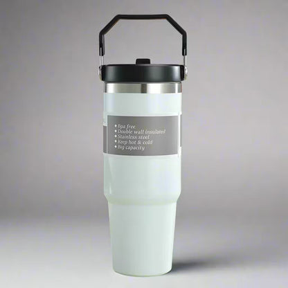 White insulated tumbler with black lid and handle on a gray background