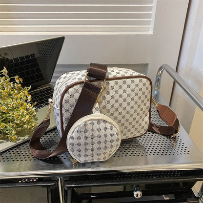 Patterned handbag with matching round pouch on a metal surface