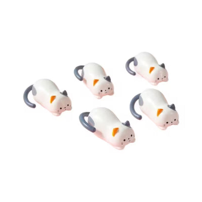 Five small white and pink mouse-shaped figurines on a white background
