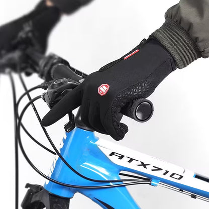 Close-up of a gloved hand on a bicycle handlebar with a blue bike frame labeled 'ATX710'.
